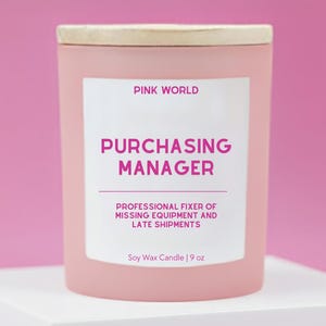 May include: A pink soy wax candle with a wooden lid. The label reads "PINK WORLD PURCHASING MANAGER PROFESSIONAL FIXER OF MISSING EQUIPMENT AND LATE SHIPMENTS." The candle is 9 oz.