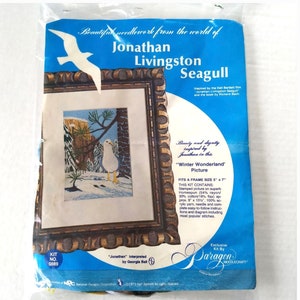 May include: A vintage Paragon Needlecraft kit featuring a framed needlepoint picture of a seagull in a winter scene. The kit includes Homespun fabric, yarn, a needle, and instructions. The package is blue with white text and a seagull illustration.