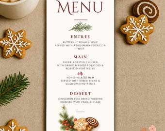 May include: A festive menu card with the word "MENU" in burgundy script. The menu lists entree, main, and dessert options. Gingerbread cookies and a sprig of evergreen are arranged around the card. The text reads "Cheers! 'Tis the season to overshare."