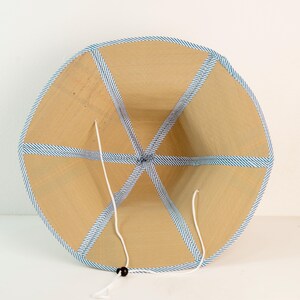 Inside view of the hat with blue trim, showcasing six-panel construction and secure chin strap for adjustable fit and comfort.