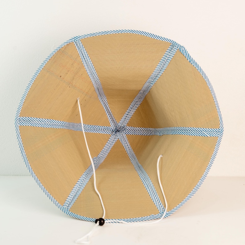 Inside view of the hat with blue trim, showcasing six-panel construction and secure chin strap for adjustable fit and comfort.