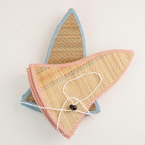Foldable straw hat shown neatly collapsed for portability. Compact and easy to carry, this hat is travel-friendly while keeping its stylish look and functionality.