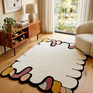 Abstract golvend vloerkleed, moderne onregelmatige vorm, crèmekleurige tapijten met veelkleurige randen