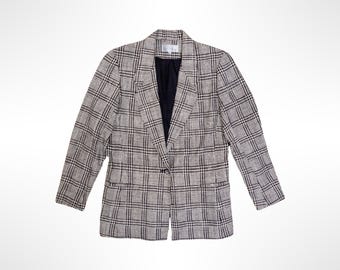 May include: A long-sleeve blazer featuring a beige and black plaid pattern. The garment has a notched lapel, a single-button front closure, and two front pockets. The interior is lined with a solid black fabric, and the structure includes shoulder pads.