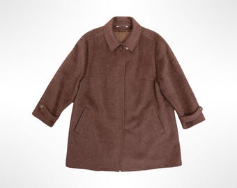 May include: A brown coat with a textured finish, featuring a classic collar, a button-front closure, and long sleeves with decorative buttoned tabs at the cuffs. The garment includes two slanted side pockets and a smooth interior lining.