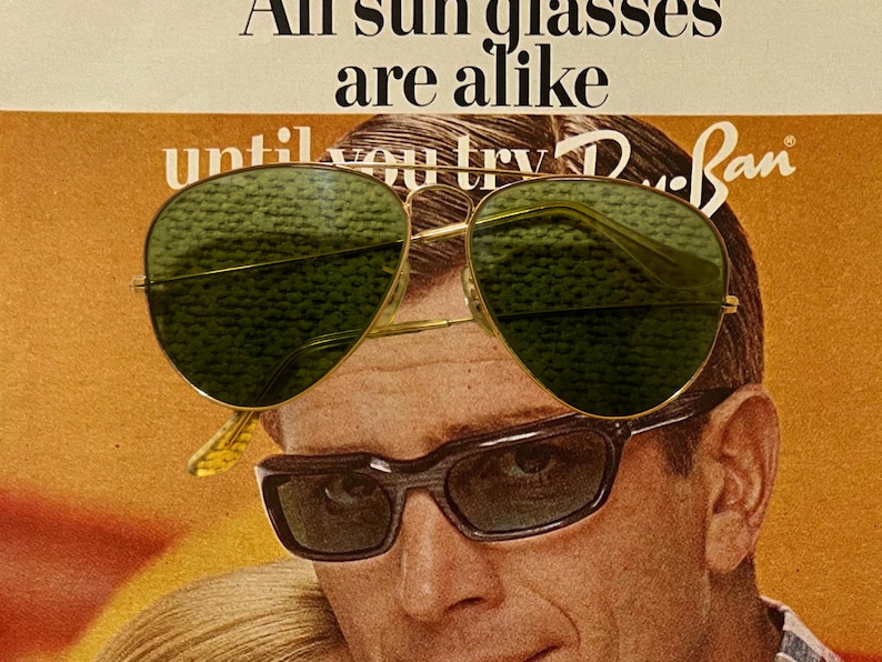 May include: Vintage advertisement featuring a man wearing two pairs of sunglasses. The top pair is gold-rimmed aviator style with green lenses. The bottom pair is a dark, rectangular frame. Text at the top reads "All sunglasses are alike" and "Ray-Ban" is visible.