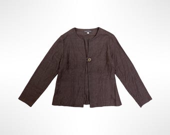 May include: A dark brown long-sleeved jacket with a round neckline and a single button closure at the center front. The garment features a textured fabric finish and a straight hemline, providing a simple and clean design for everyday wear.