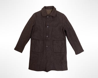 May include: A dark brown coat featuring a classic collar, long sleeves, and a front button closure with four visible buttons. The garment includes two large patch pockets on the lower front section and vertical seam detailing along the torso.