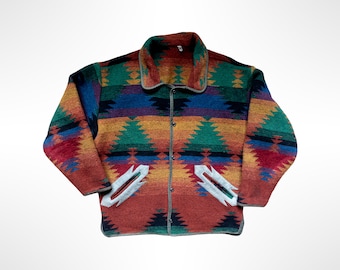 May include: A long-sleeve button-up jacket featuring a multi-colored geometric pattern in shades of red, orange, yellow, blue, and green. The jacket includes a fold-down collar, a front button closure, and two white-trimmed pockets on the front.