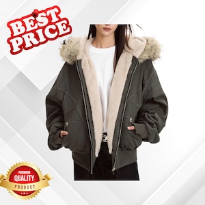 May include: A dark green bomber jacket with a faux fur-lined hood and a cream-colored interior. The jacket has a zipper closure, pockets, and ribbed cuffs. The image includes the text "BEST PRICE" and "PREMIUM QUALITY PRODUCT".