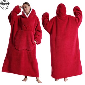 May include: Red hooded blanket with an apple-shaped pocket. The blanket has a white fleece lining around the hood. The image shows the front and back of the blanket. The blanket is made of a soft, plush material.