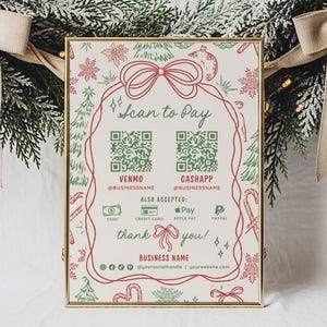 May include: A framed sign with a gold border, featuring the text "Scan to Pay" and QR codes for Venmo and CashApp. The sign is decorated with red and green Christmas-themed illustrations, including bows, candy canes, and snowflakes. The sign is set against a backdrop of a Christmas wreath.