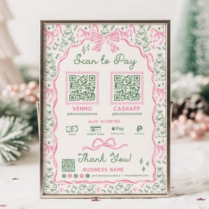 May include: A framed sign with a pink and green Christmas-themed design. The sign reads "Scan to Pay" and includes QR codes for Venmo and Cash App, along with accepted payment methods. The text "Thank You!" and business details are also displayed.