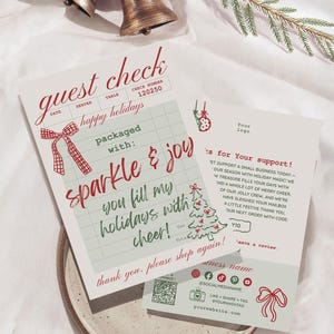 Może przedstawiać: Paragon dla gości i kartka z podziękowaniami o tematyce świątecznej. Na paragonie widnieją słowa "guest check" i "happy holidays" w czerwonym skrypcie. Kartka z podziękowaniami zawiera ilustrację choinki i słowa "thanks for your support".