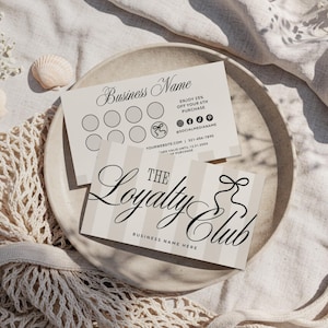 May include: Two loyalty cards with the text "The Loyalty Club" and "Business Name" on a neutral background. One card has a striped design and a bow graphic. The other card has circles for stamps and social media icons.
