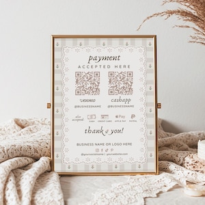 May include: A framed sign with a gold border displays "payment ACCEPTED HERE" with QR codes for Venmo and Cash App. The sign includes payment options and a "thank you" message, with space for a business name and social media handles. The background is a neutral color.