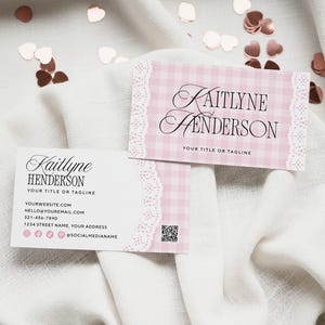 May include: Two business cards with the name "Kaitlyne Henderson" in elegant script. One card features a pink gingham pattern with lace trim, while the other is white. Both cards include contact information and social media icons.