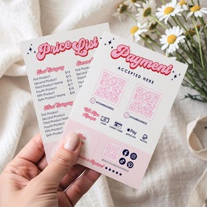 May include: Two pink and white business cards with the words "Price List" and "Payment Accepted Here" in a retro font. The cards include QR codes, social media icons, and a list of product names and prices. The cards are held in a hand.