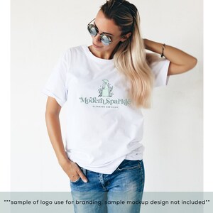 May include: A white t-shirt with a logo that says "Modern Sparkle Cleaning Services". The logo features a stylized illustration of a spray bottle with leaves and flowers.