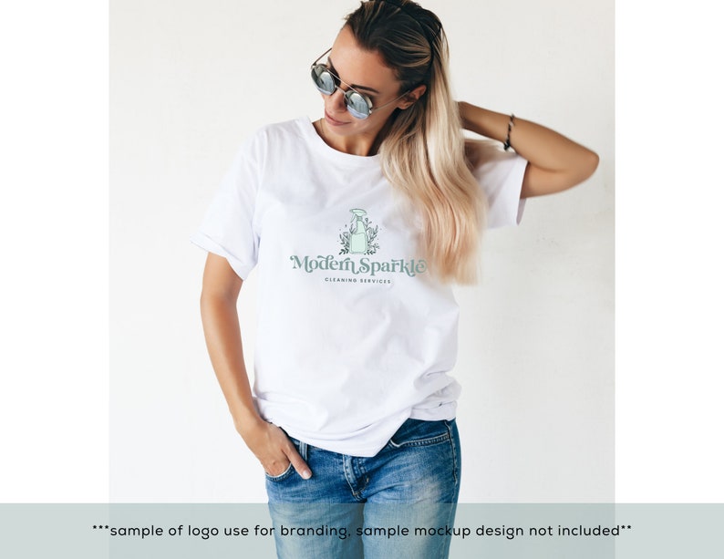 May include: A white t-shirt with a logo that says "Modern Sparkle Cleaning Services". The logo features a stylized illustration of a spray bottle with leaves and flowers.