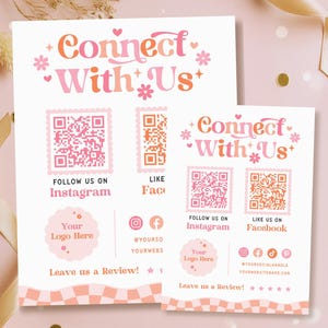 May include: Two pink and peach-coloured promotional signs with the text "Connect With Us." The signs include QR codes, social media icons, and the phrases "Follow us on Instagram" and "Like us on Facebook." The signs also say "Leave us a Review!"