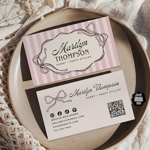 May include: Two business cards with a pink and white striped background and a bow design. The cards read "Marilyn Thompson, Event + Party Stylist." One card includes social media icons, contact information, and a QR code.