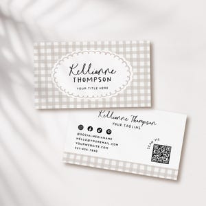 May include: Two business cards with a light gray gingham pattern. The top card has the name "Kellianne Thompson" in script within a scalloped oval, with "YOUR TITLE HERE" below. The bottom card includes social media icons, contact info, and a QR code.
