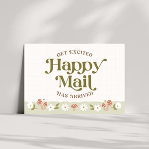 May include: A white card with a green grid pattern and the text "Get Excited Happy Mail Has Arrived". The card has a border of white flowers, green leaves, and red and white mushrooms.
