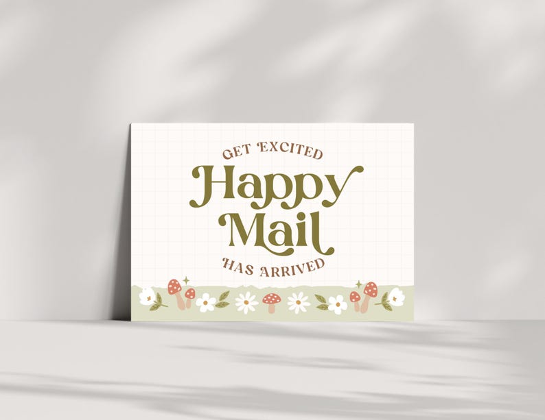 May include: A white card with a green grid pattern and the text "Get Excited Happy Mail Has Arrived". The card has a border of white flowers, green leaves, and red and white mushrooms.