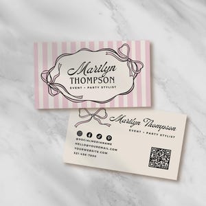 May include: Two business cards with a marble background. One card has pink and white stripes with a black bow design and the name "Marilyn Thompson, Event + Party Stylist." The second card is off-white with contact information.