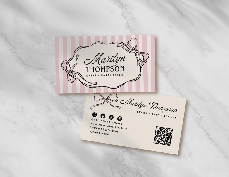May include: Two business cards with a marble background. One card has pink and white stripes with a black bow design and the name "Marilyn Thompson, Event + Party Stylist." The second card is off-white with contact information.