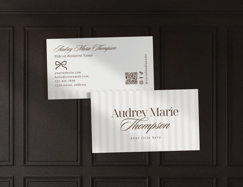 Puede incluir: Dos tarjetas de visita con el nombre "Audrey Marie Thompson". Una tarjeta tiene un lazo y datos de contacto. La otra tiene rayas verticales y el texto "your title here".