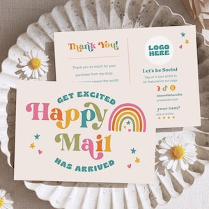 May include: Two cream-colored cards with colorful text and graphics. One card reads "Happy Mail Has Arrived" with a rainbow graphic. The other card says "Thank You!" and includes social media information. Daisies decorate the background.