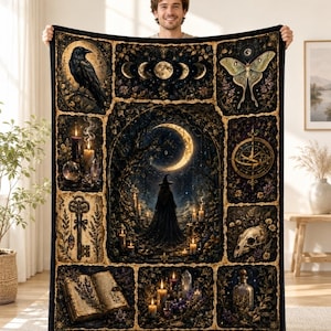 May include: A rectangular throw blanket featuring a dark, mystical collage design. The central panel shows a figure in a cloak under a crescent moon. Surrounding panels depict a raven, moon phases, a moth, a key, a skull, a book, and candles.