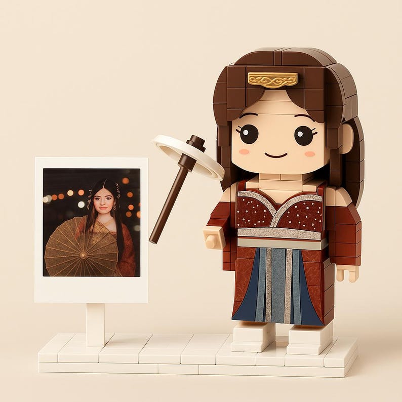 May include: A brick-built figure of a woman in a traditional Asian-inspired outfit, holding a parasol. The figure has a brown hair and a red and blue dress. A photo of a woman with a parasol is next to the figure.