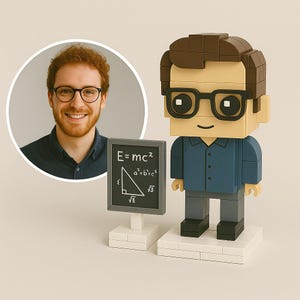 May include: A block figure of a person wearing glasses and a blue shirt, holding a small chalkboard with mathematical formulas. A photo of a person with glasses is in the background. The chalkboard displays the equation E=mc² and other formulas.