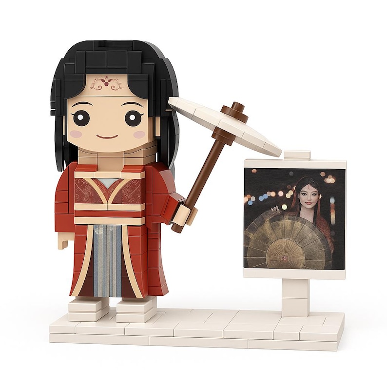 May include: A brick-built figure of a woman in a red and beige traditional outfit, holding a white parasol. The figure stands next to a sign with a picture of a woman with a fan. The figure has black hair and a smiling face.