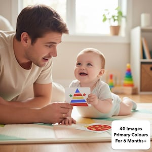 May include: A baby and a man are looking at flashcards with colourful designs. The baby is holding a card with a triangle and star design. The text on the bottom right reads "40 Images Primary Colours For 6 Months+".