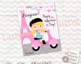 May include: A pink and white Valentine's Day card featuring a cartoon girl riding a pink scooter in front of the Eiffel Tower. The card says "Bonjour! Happy Valentines Day!" and "Your friend".