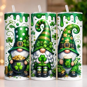 May include: Three cylindrical tumblers with clear straws, featuring St. Patrick's Day themes. The designs include green gnomes, leprechaun hats, pots of gold coins, shamrocks, and green slime drips on a white background with green striped accents.