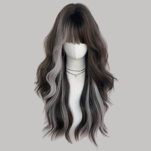 May include: A long, wavy wig with a dark brown base and grey highlights. The wig features a blunt fringe and is styled on a mannequin head. The hair cascades down the shoulders, creating a voluminous and stylish look. The wig is designed for fashion or cosplay.