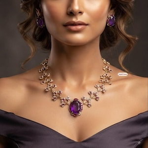 May include: A gold necklace featuring a large oval purple amethyst center stone surrounded by smaller red rubies and clear diamonds in a branch-like setting, paired with matching oval purple amethyst stud earrings in gold settings.