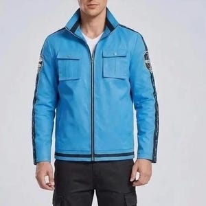 May include: A light blue leather jacket with a zip-up front, two chest pockets, and black stripes on the sleeves. The jacket has a stand-up collar and black trim. The model is wearing black cargo pants.