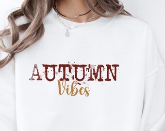 Sudadera Autumn Vibes: Estampado retro otoñal, jersey holgado y cómodo.