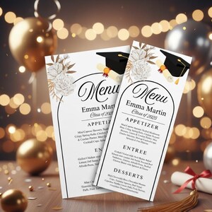May include: Two graduation menu cards with the name "Emma Martin" and the class year. The menus feature a black graduation cap and diploma graphic, with floral accents. The menu includes appetizers, entrees, and desserts.