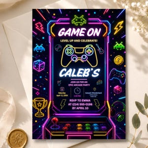 May include: A rectangular party invitation featuring a neon-style arcade cabinet design on a black background. The text reads GAME ON, LEVEL UP AND CELEBRATE, CALEB'S, JOIN US FOR AN EPIC ARCADE PARTY, Saturday April 12, 20XX, 3:00 PM, Aanya's Wonderland, RSVP TO EMMA AT (214) 555-0186 BY APRIL 10.