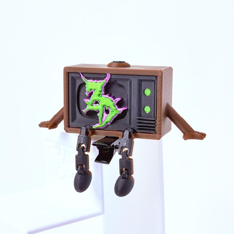 Brown, black, green and purple Zeds Dead TV buddy pulled straight from Zeds Dead's signature aesthetic