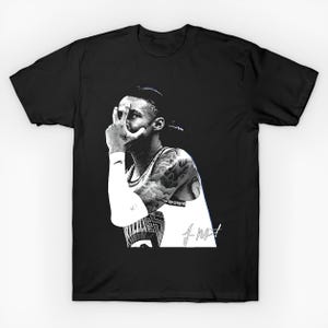 May include: Black t-shirt featuring a black and white graphic of a person making a hand gesture. The person has tattoos and is wearing a white undershirt. The shirt has the text "fms" in white.