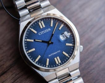 Relógio esportivo de luxo Citizen Tsuyosa automático com mostrador texturizado em granito, 40 mm, pulseira integrada em aço inoxidável e vidro de safira (Ref. NJ0151-88L).