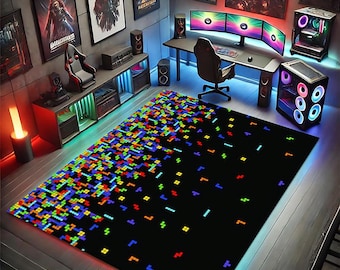 May include: Black rectangular area rug with a pixelated design in various colors, including blue, green, red, and yellow. The rug is placed in a gaming room setting, with a desk, computer, and gaming accessories visible.
